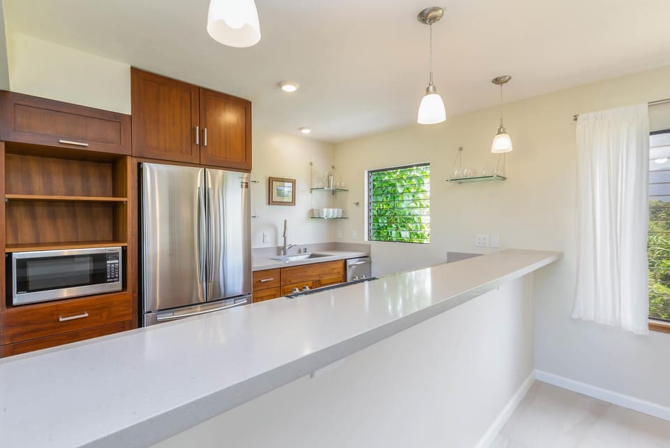 Hang out around the sparkling kitchen bar; four stools not shown pic