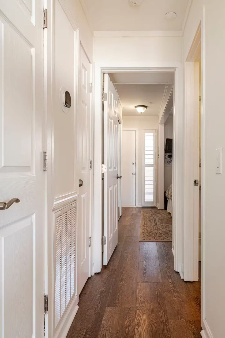 Hallway from the entrance to the unit. Updated LVP floors throughout the condo