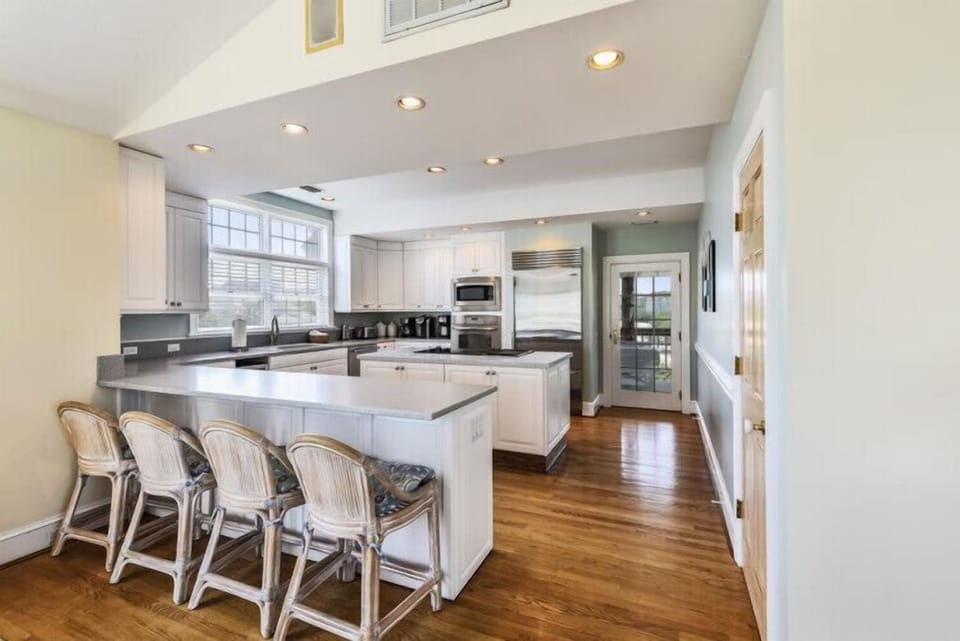 Your fully equipped kitchen features stainless steel appliances, spacious countertops, and a breakfast bar with seating for casual meals and morning coffee together.