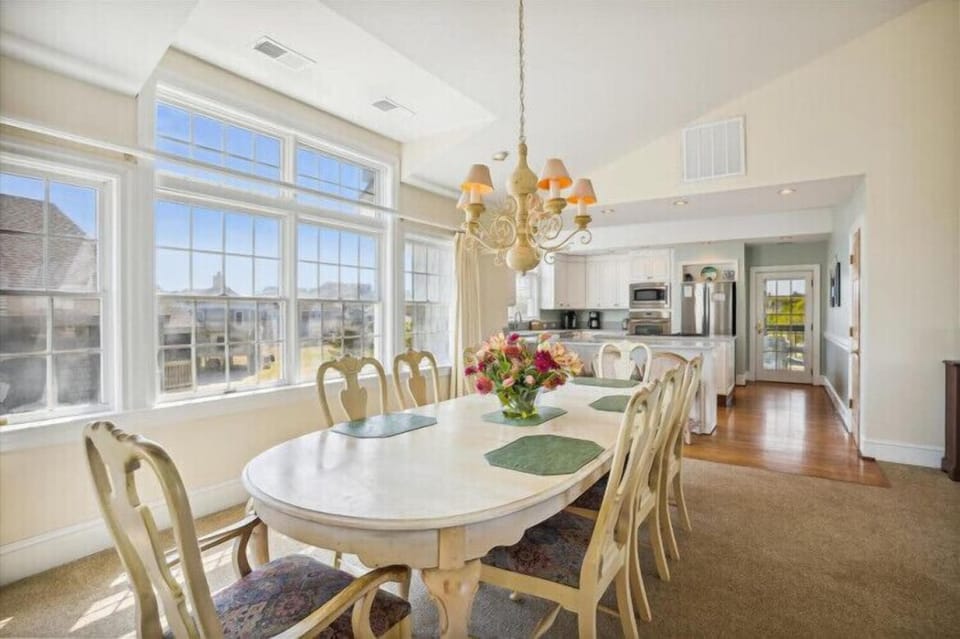 Gather around this elegant dining table for memorable meals, with sunlight streaming through large windows and your private kitchen steps away.