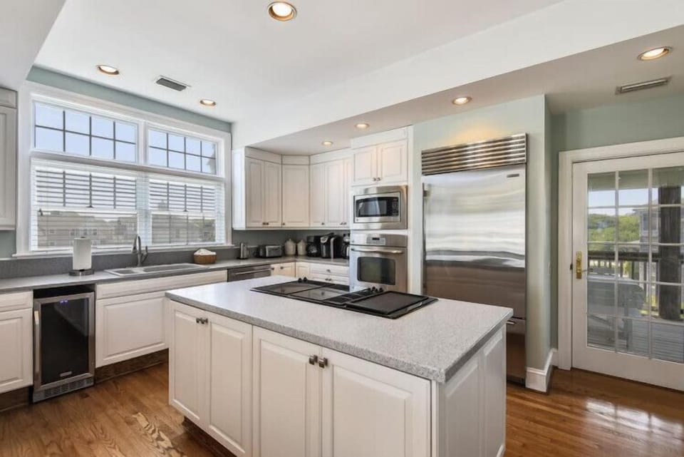 Prepare delicious meals in your spacious kitchen, fully equipped with stainless steel appliances, a center island cooktop, and ample counter space for all your culinary adventures.