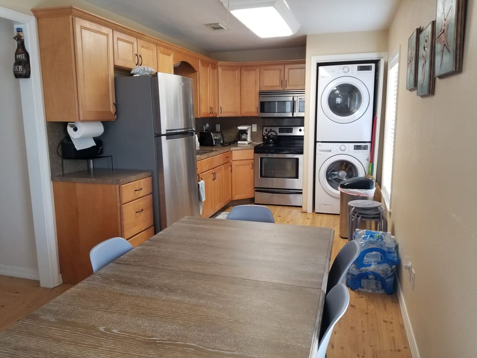 Kitchen view with Refridgerator, Washer, and Dryer.