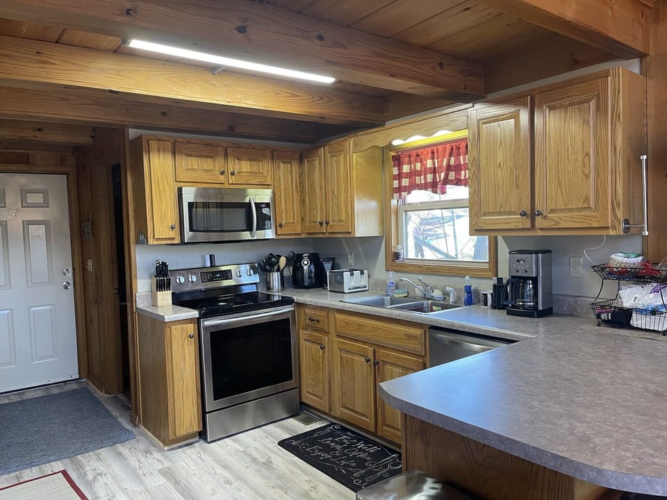 Fully stocked kitchen with cookware, plates and all needed accessories.