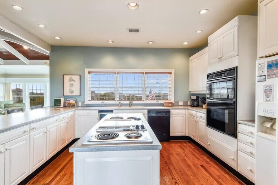 Your spacious gourmet kitchen invites culinary creativity with gleaming countertops, abundant cabinetry, and top-tier appliances—all bathed in natural light from scenic windows overlooking beautiful vistas.
