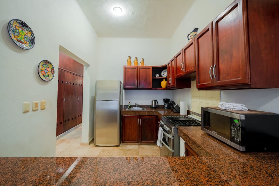 Family Apartment, Multiple Beds | Private kitchen | Full-size fridge, microwave, oven, stovetop