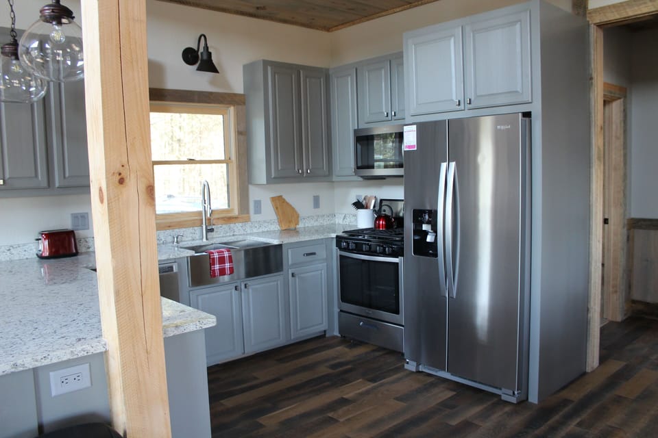 Kitchen with gas stove and stainless steel appliances. 