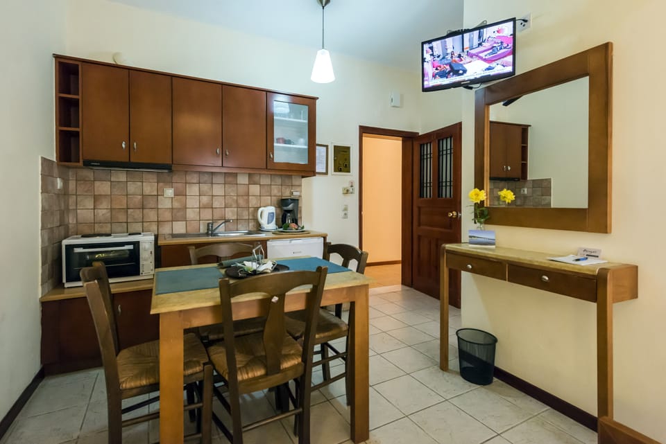 Family Apartment, Garden View | Living area | 32-inch flat-screen TV with satellite channels, TV, books