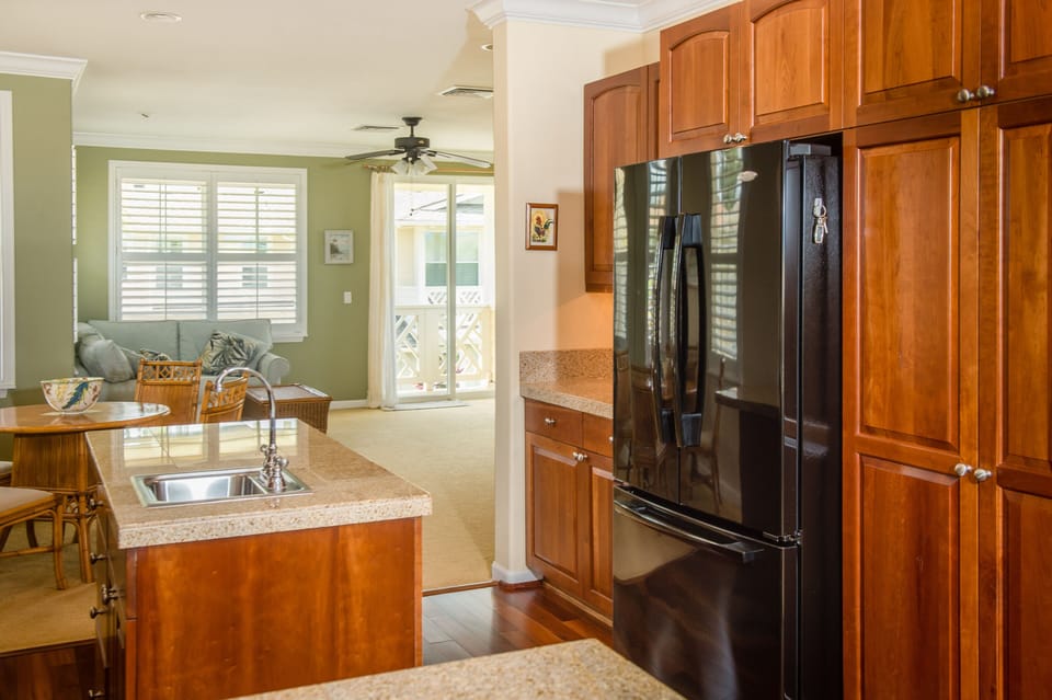 Kitchen - Kitchen with large pantry and three-door refrigerator and freezer looking toward breakfast nook and den