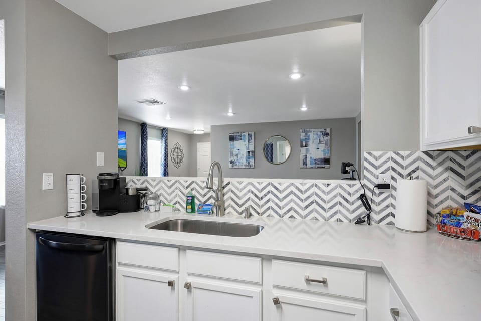 Kitchen, coffee maker, dishwasher overlooking living room