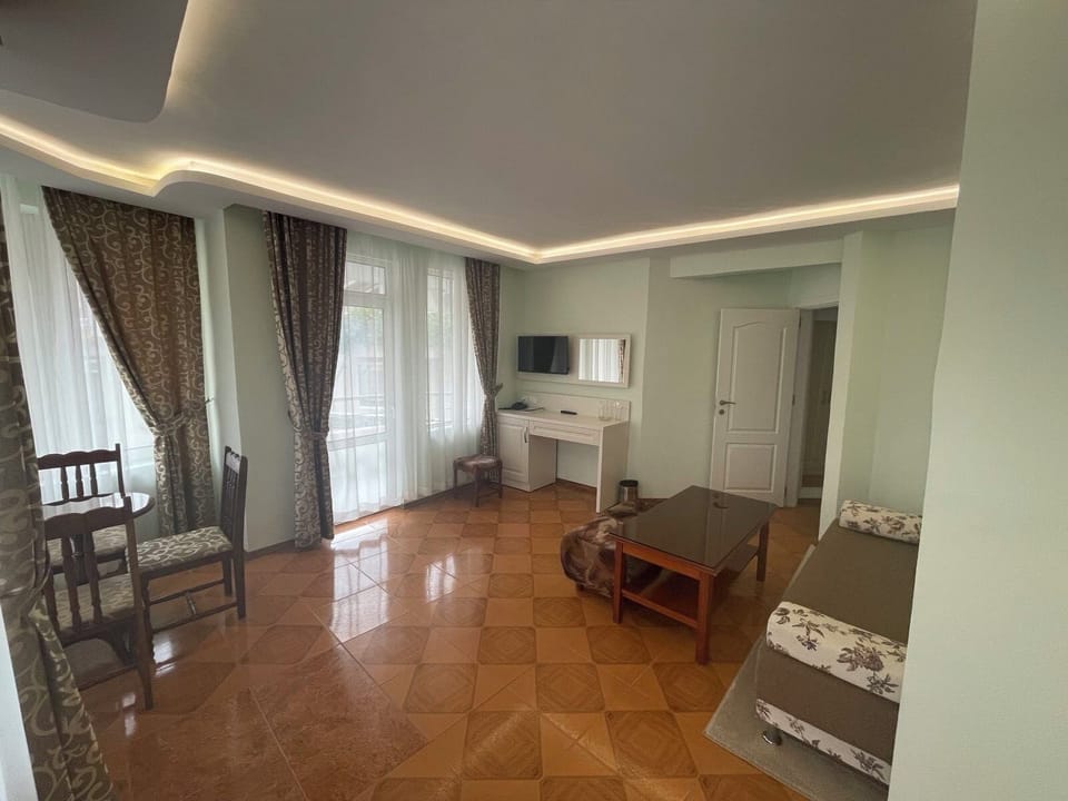 Basic Apartment, 1 Bedroom, Balcony, City View | Living area | 28-inch flat-screen TV with cable channels, TV