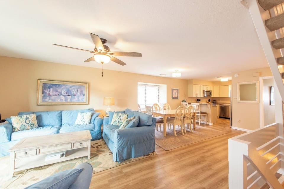 Settle into the main level after a long beach day — open layout, coastal touches throughout, and the kind of living space that fits nine people without anyone feeling crowded.
