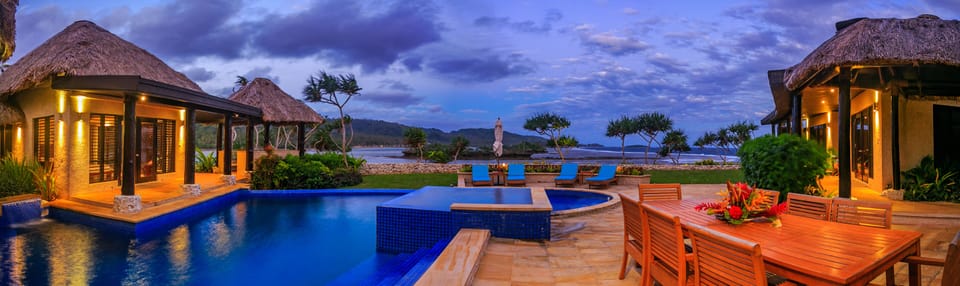 Outdoor dining poolside with view across the South Pacific seas