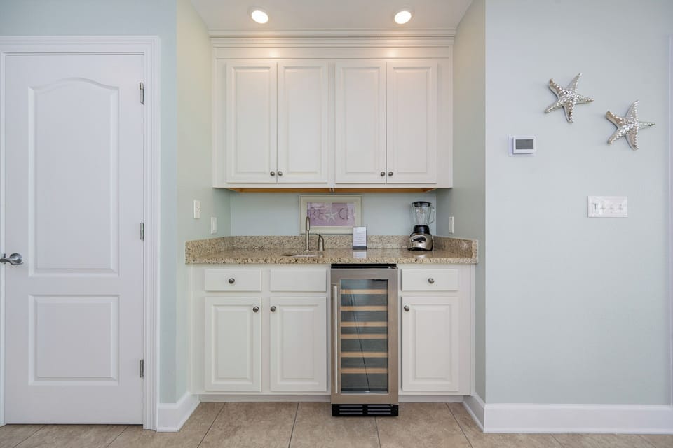 Grab a chilled bottle from the wine cooler or create your favorite cocktail at this elegant wet bar