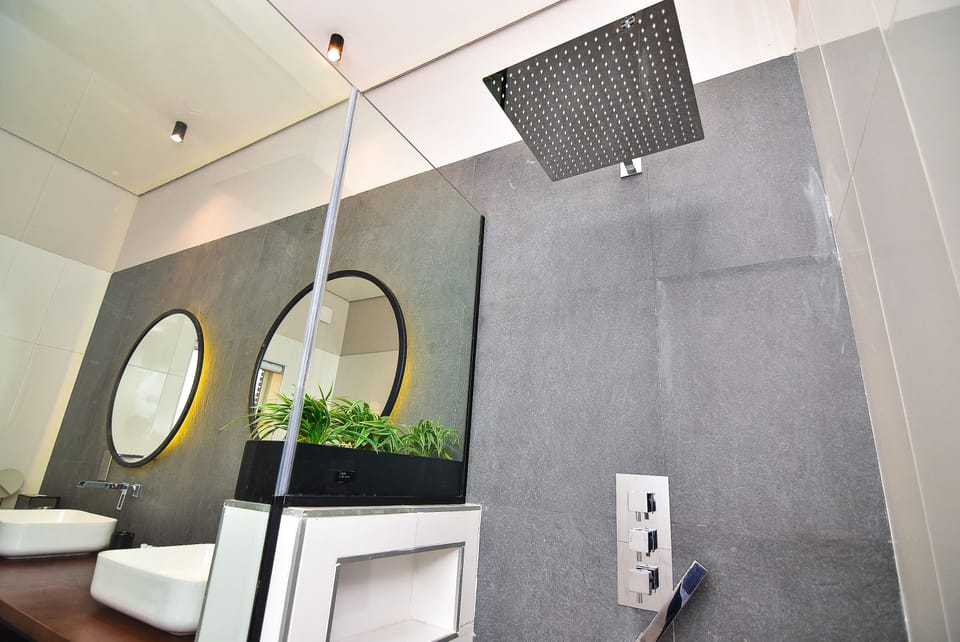 Deluxe Studio | Bathroom | Shower, rainfall showerhead, designer toiletries, hair dryer