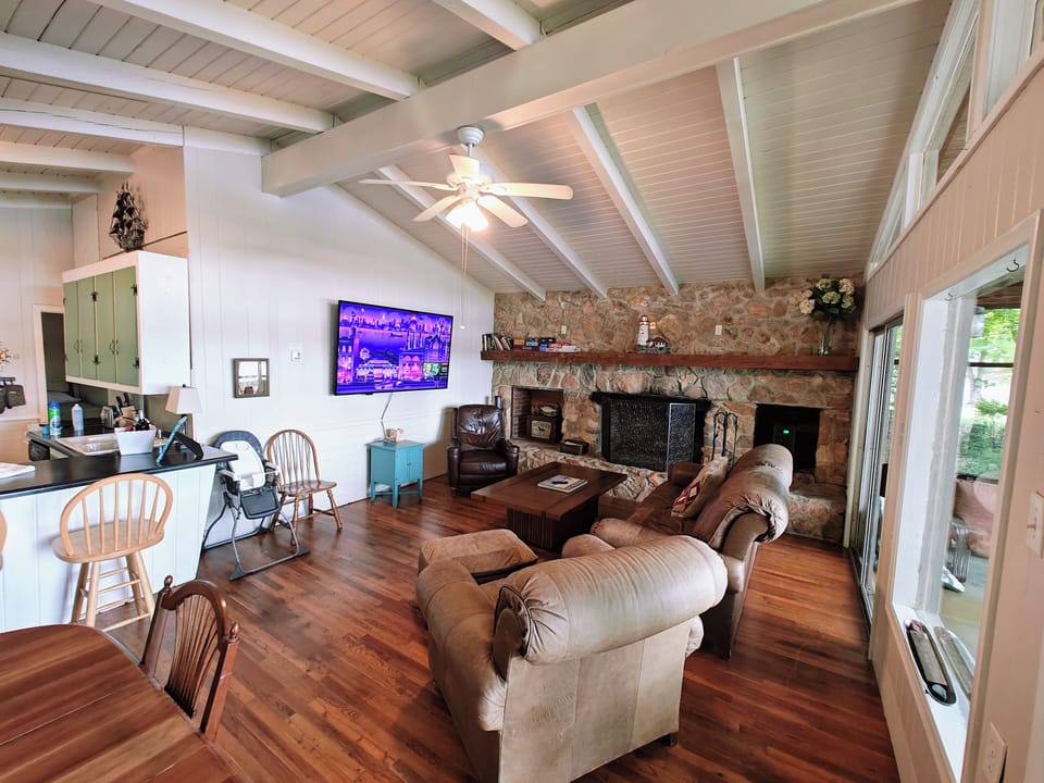 Comfortable living room with decorative stone fireplace (not safe for burning)