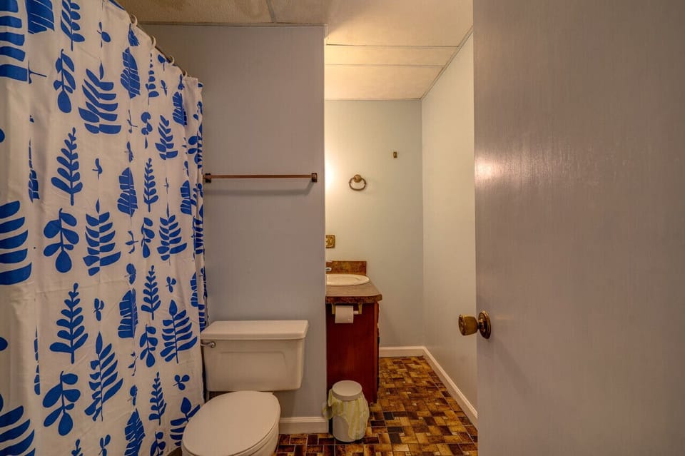 The lower level bath has a tub/shower combo, sink and commode
