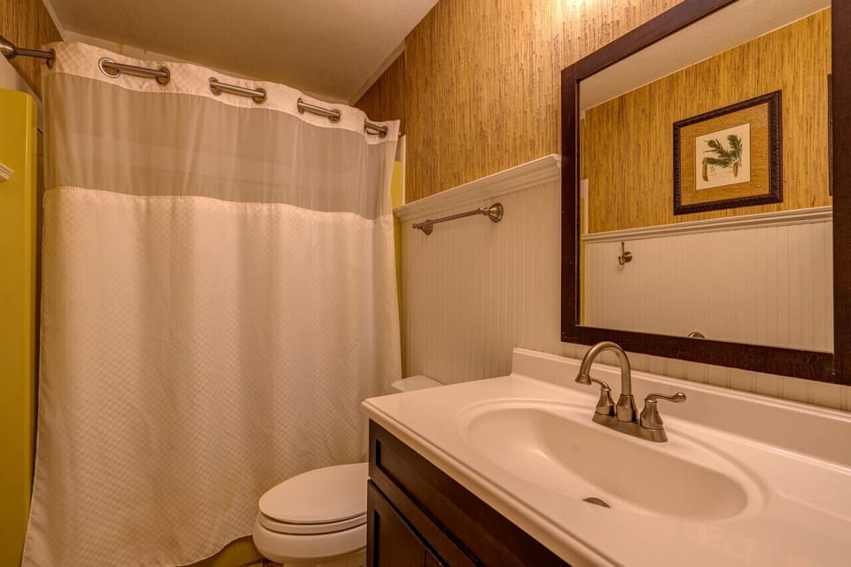 The entry level bath has a shower/tub combo, sink and commode