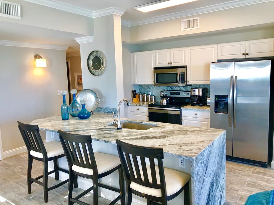 Breakfast bar with granite waterfall countertops.  
