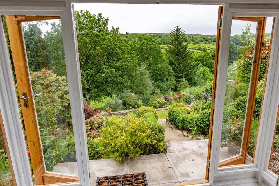 View from the summer house looking onto the garden and terrace.