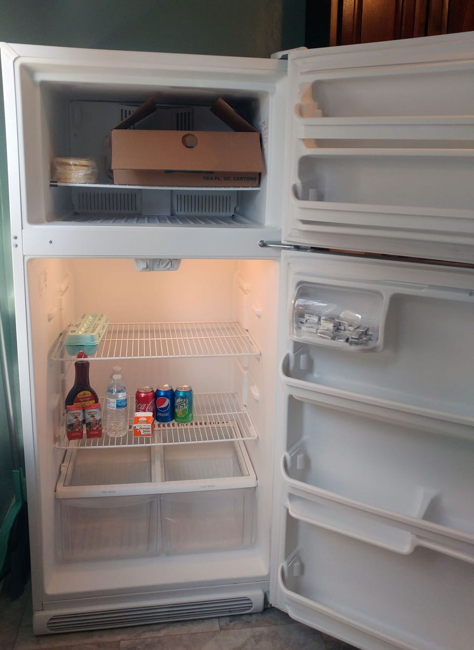 Kitchen stocked with breakfast food like waffles, eggs, milk, juice, water & pop