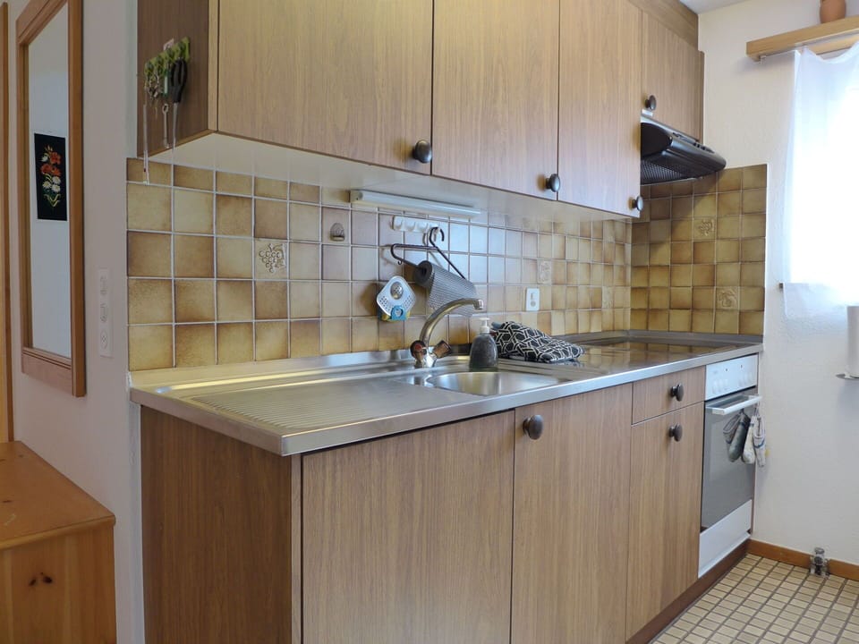 Countertop, Cabinetry, Kitchen Sink, Tap, Kitchen, Kitchen Stove, Kitchen Appliance, Wood, Building, Lighting