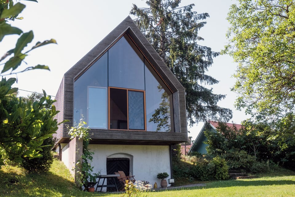 House exterior, front glass facade, and the garden.