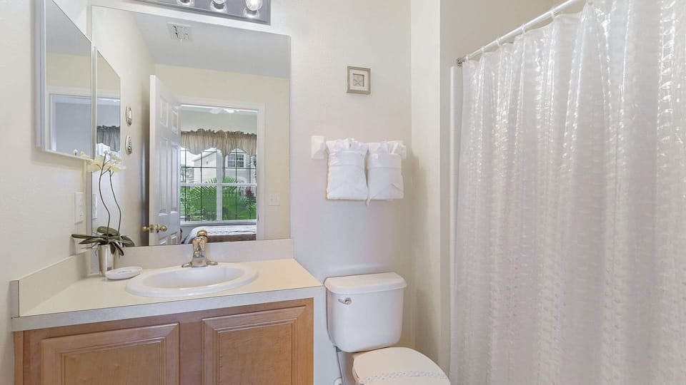 Relax and unwind: Bathroom with shower/tub combo in Bedroom 4.