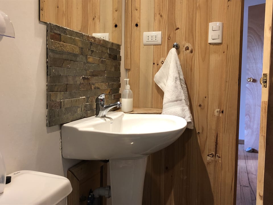 Shower, hair dryer, slippers, towels