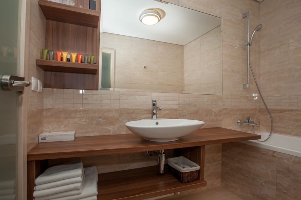 Apartment | Bathroom | Bathtub, bathrobes, slippers, towels