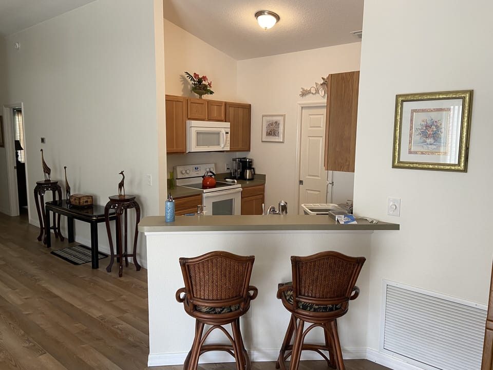 Kitchen with counter seating, a phone charging station, and a Keurig