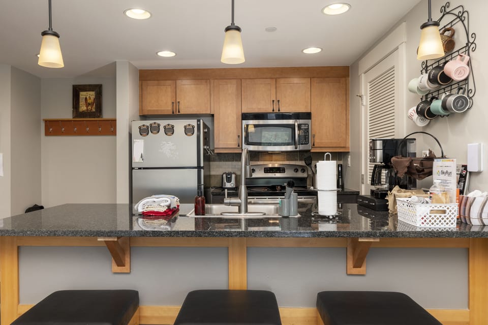 - Modern kitchen with stainless steel fridge and microwave   - Breakfast bar seating makes dining easy and convenient   - Open layout flows to living and dining for gatherings
