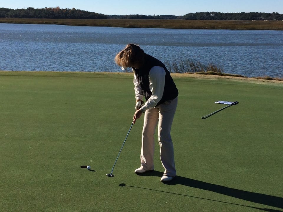 Golfer playing the 18th hole on the Cotton Dike golf course