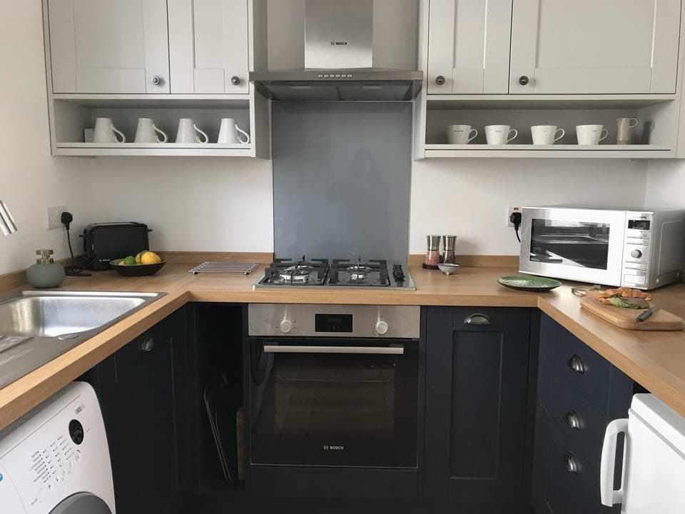 Kitchen with Nespresso coffee machine, dishwasher, and washing machine
