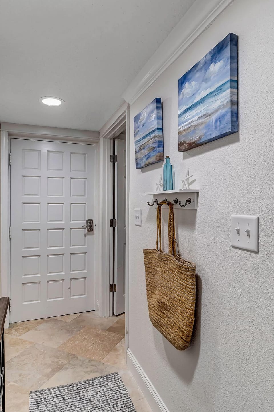 - Welcome nook with beach inspired hooks, art, and a woven bag for daily outings
- Convenient wall rack for towels, hats, or beach gear right by the front door
- Simple, cheerful touches make arrivals and departures a breeze