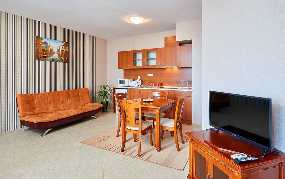 Apartment, 1 Bedroom, Balcony | Living area | 32-inch TV with cable channels