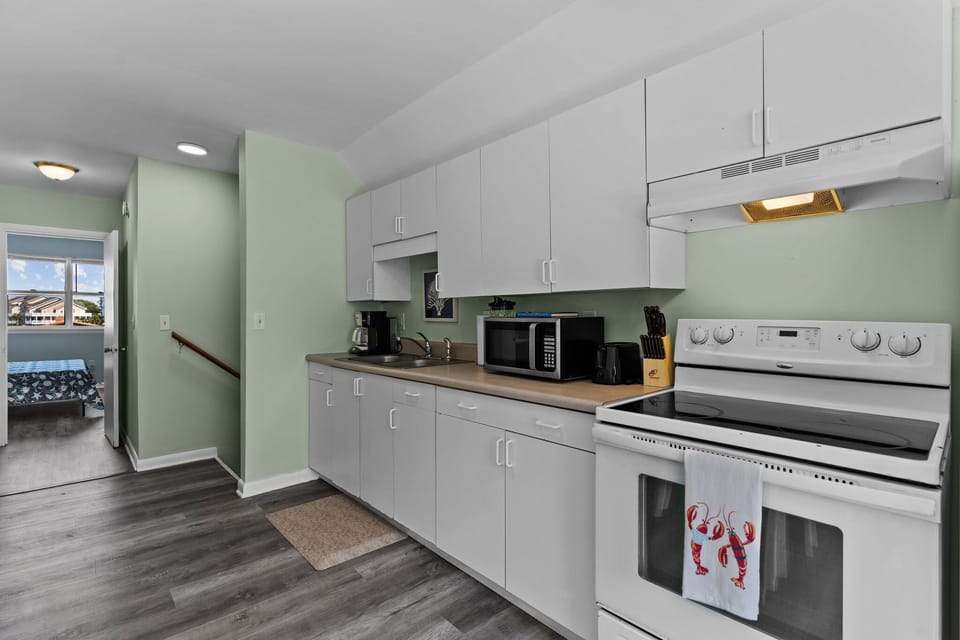 Your fully equipped kitchen awaits with modern appliances, ample counter space, and everything needed to create memorable meals during your stay.