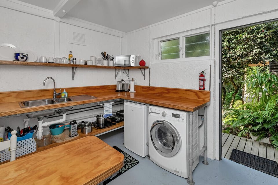 Seperate kitchen, with usual amenities, small fridge, microwave, kettle, toaster and washing machine/dryer.