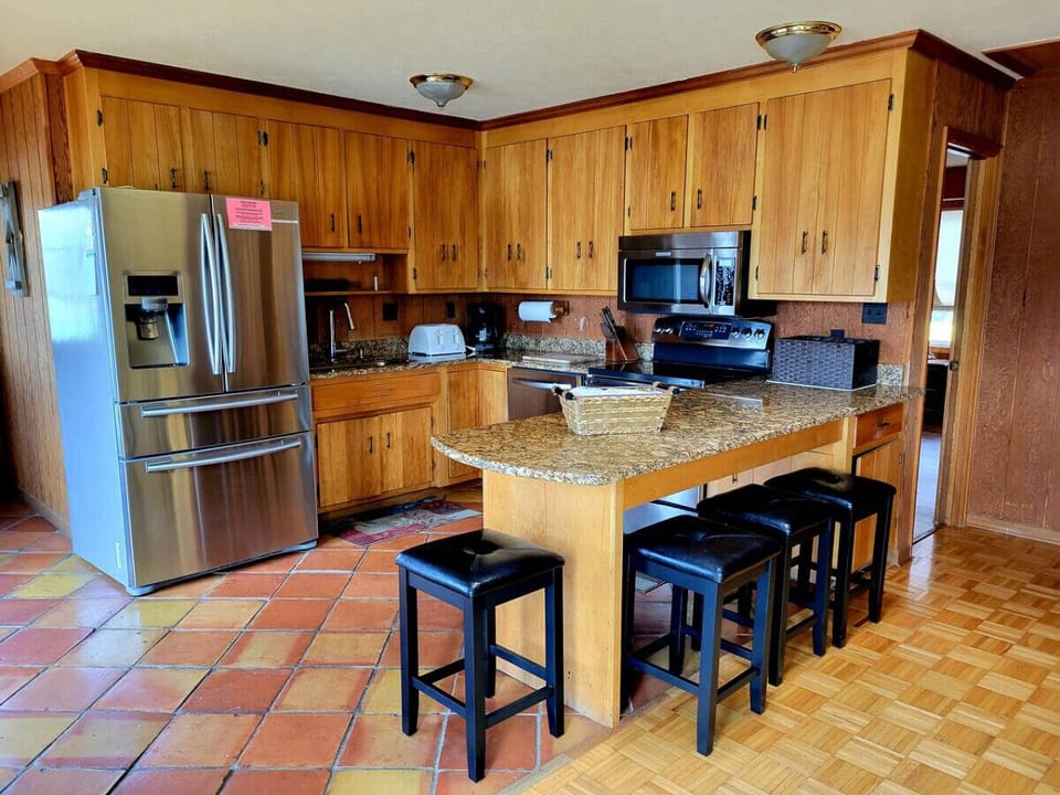 Modern kitchen with essentials for home-cooked meals and gatherings.
