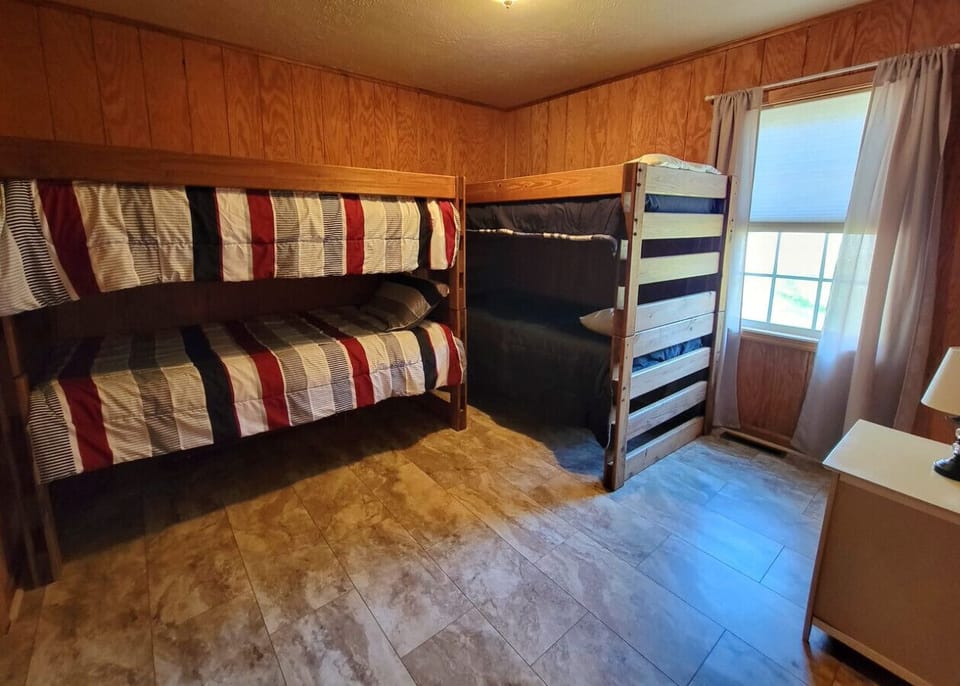 The bedroom features two sets of bunk beds, perfect for the kids.