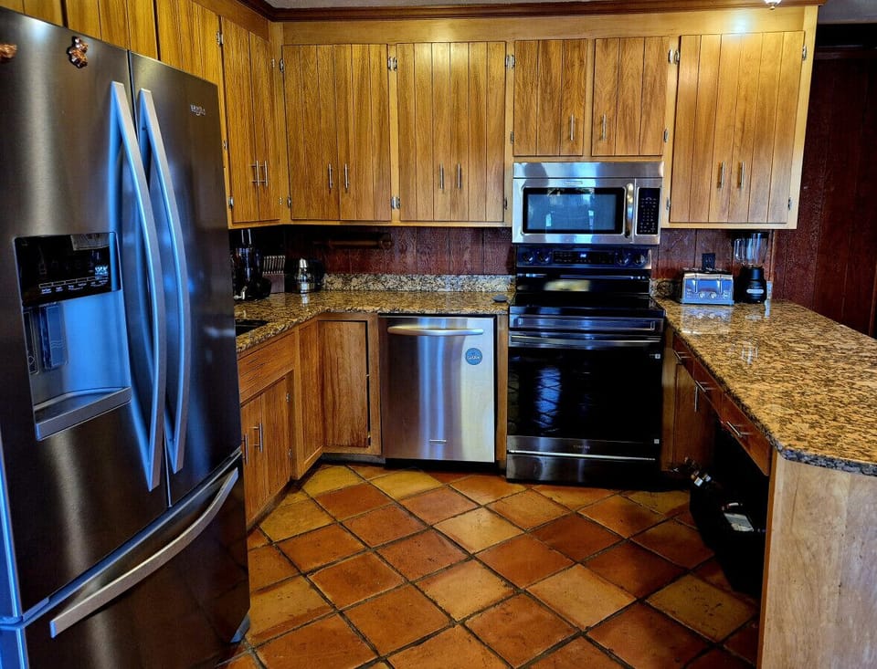 Modern kitchen with essentials for home-cooked meals and gatherings.