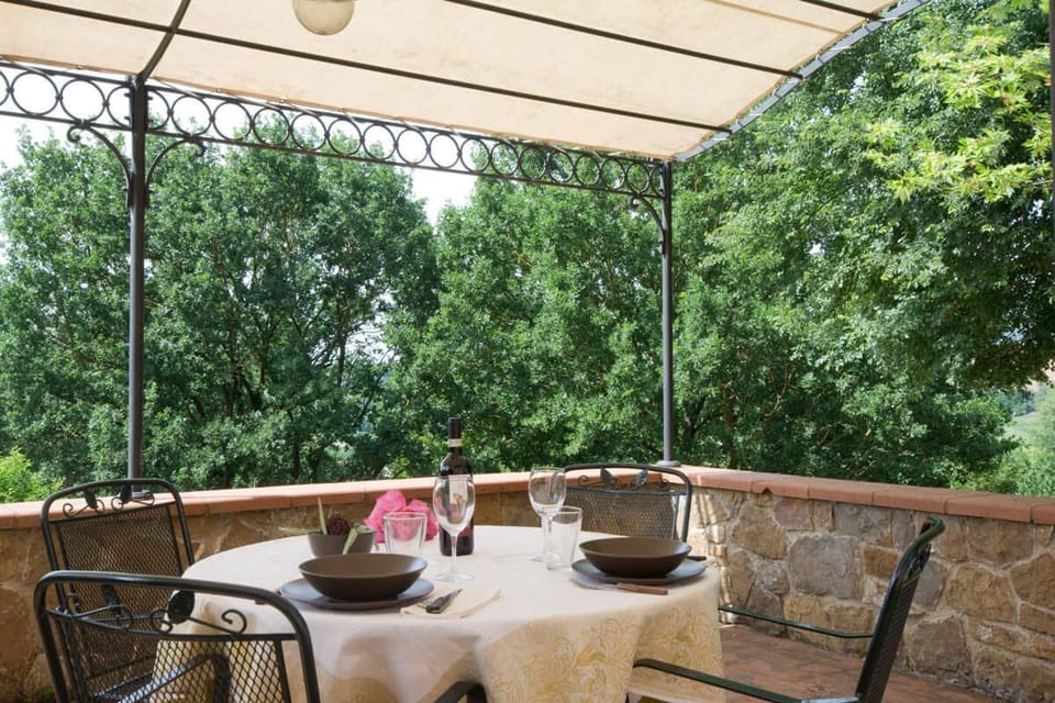To one side of the house is this charming shaded pergola, perfect for alfresco meals