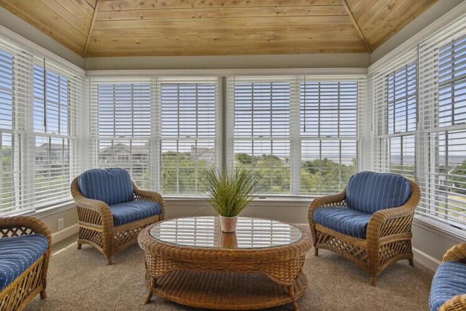 Settle into this sunlit sanctuary with wicker seating and panoramic views. Your peaceful morning coffee spot awaits, where natural light and gentle breezes create the perfect retreat.