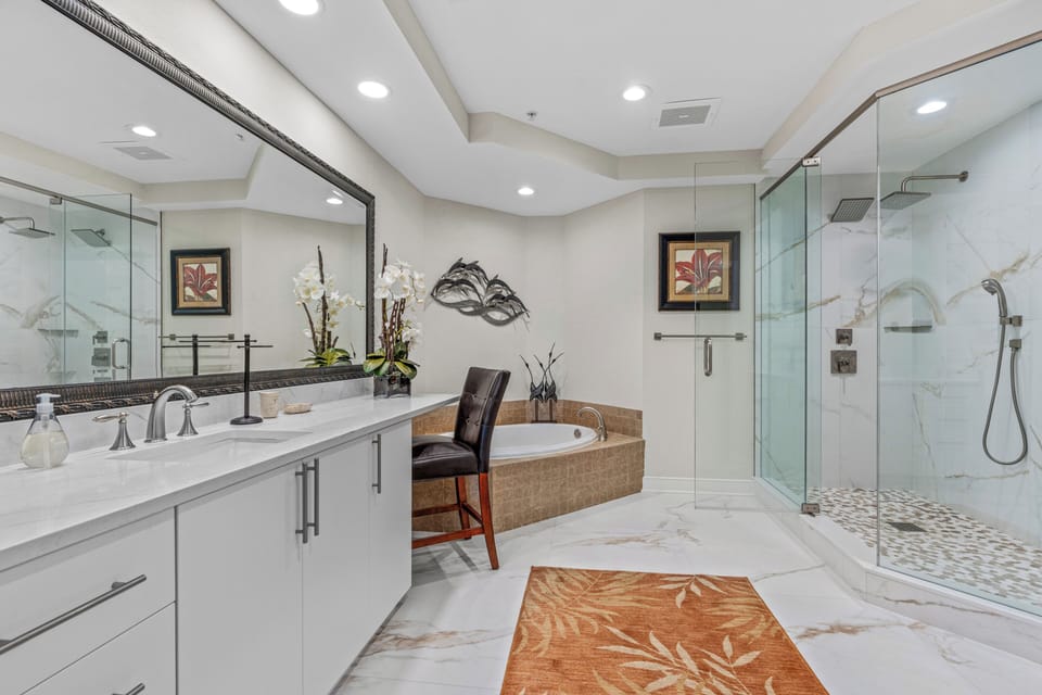The Master Bath with two shower heads, two sinks, and a soaking tub.