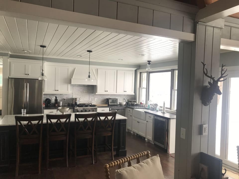 Gourmet kitchen with  commercial gas range and stainless steel appliances. 