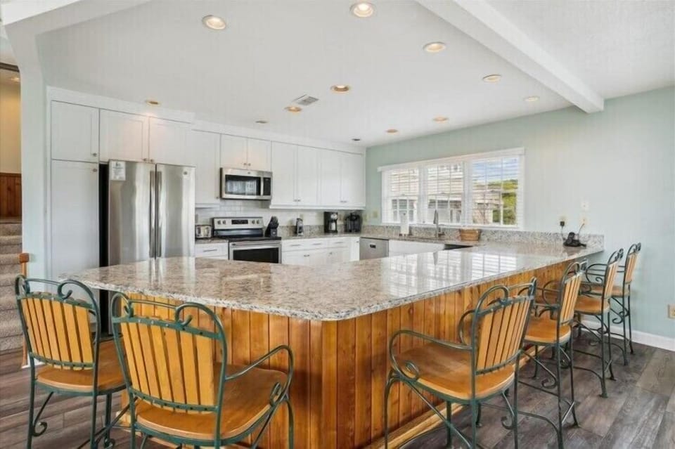 Picture yourself gathering around this gleaming granite island with your group, sharing meals and stories. The bright, fully-equipped kitchen opens up your vacation to home-cooked memories.