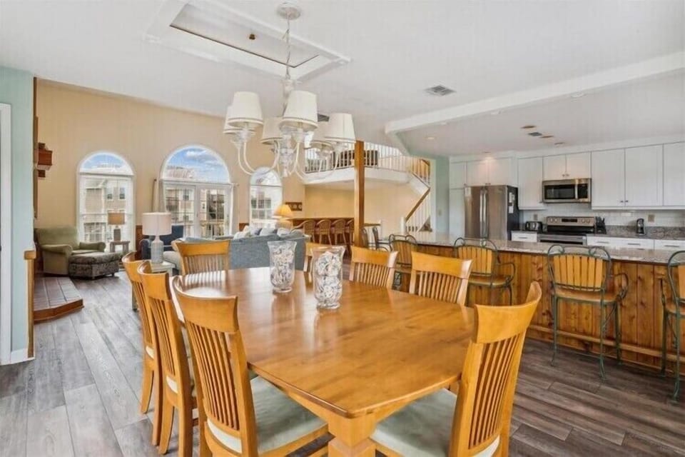 Step into your spacious vacation haven where dining, cooking, and lounging blend seamlessly. Natural light pours through arched windows, illuminating the open floor plan and inviting you to gather with loved ones.