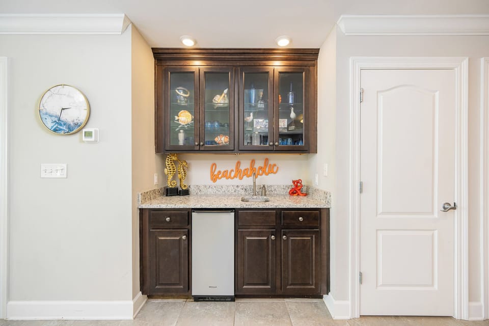Grab a chilled drink from the fridge or create your favorite cocktail at the wet bar with fun beach decor