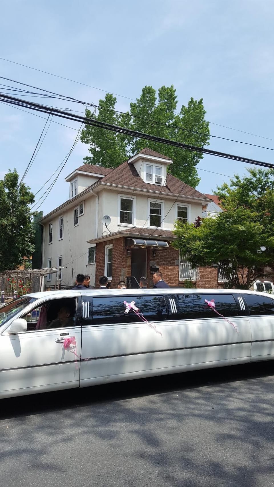 Limo parked in front of the house to pick up the bride & her bridesmaids after their one night stay at the apartment the night before her wedding. 