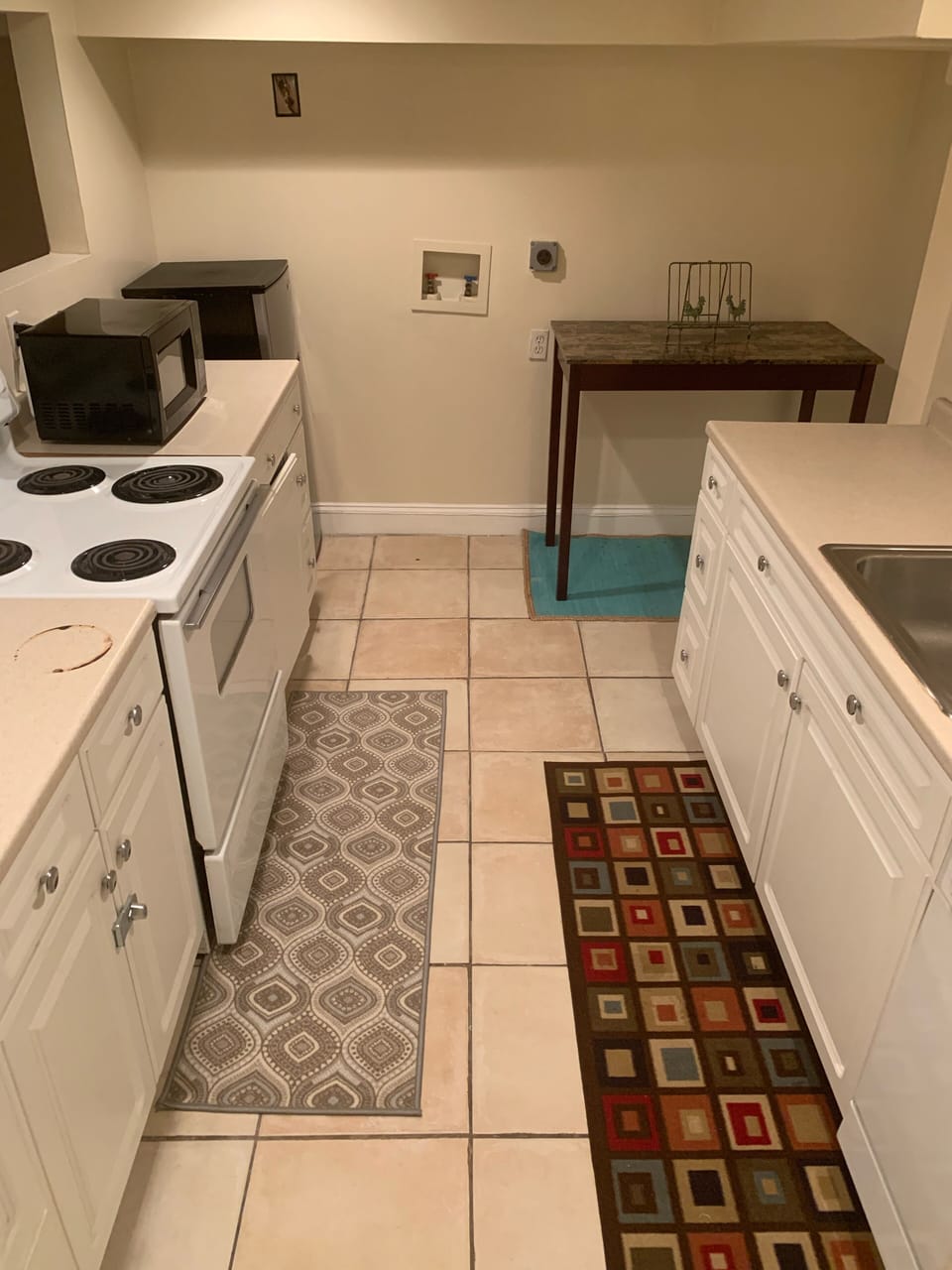 Kitchen with stove, microwave, and refrigerator.