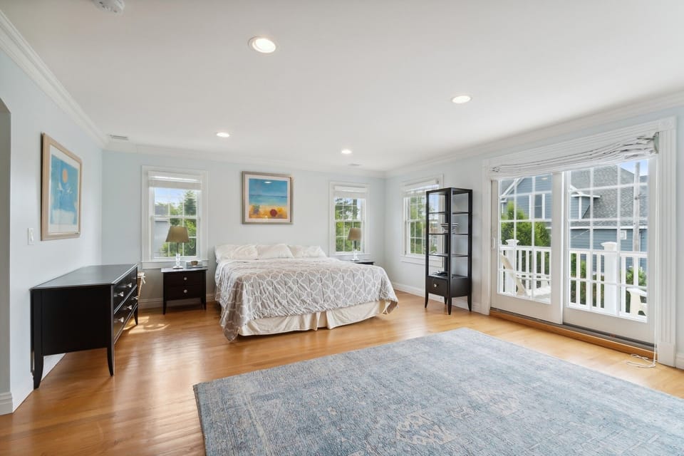 Primary bedroom, showing king-bed and porch looking down on pool area. 